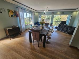 a living room with a table and a couch at Family Home with Entertainment Area in Westville