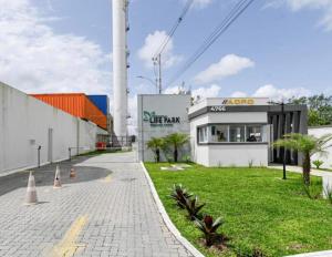 a building with a green lawn in front of it at Apartamento Pelotas in Pelotas