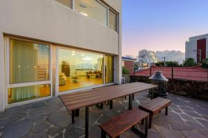 a wooden bench sitting next to a building at Hold in Hamdeok with beach in Jeju