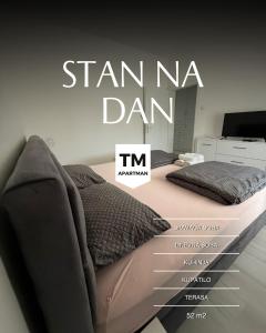 a bed with a sign that reads stan nea dan at T&M Apartman in Paraćin