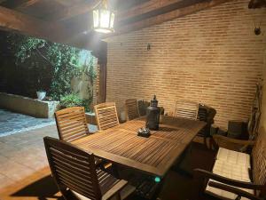 a wooden table and chairs on a patio at La Casa del Lago in Mesones