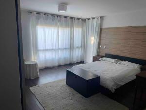 a bedroom with a bed and a large window at La Casa del Lago in Mesones
