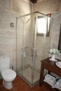 a bathroom with a shower with a toilet and a sink at Vilaboa Paradise in Villanueva +8 photos