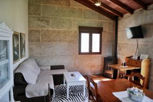 a living room with a couch and a table at Vilaboa Paradise in Villanueva