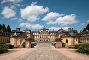a large yellow building with a blue sky at Ferienhaus Landblick in Bad Arolsen