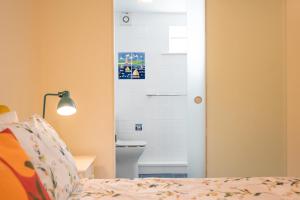 a bedroom with a bed and a white door at Sedge Cottage "Barn", Reydon in Reydon +15 photos