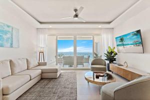 a living room with a couch and a table at Luxury Oceanview Condo with Pool in Tamarindo
