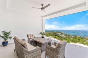 a dining room with a table and chairs and a large window at Infinity Pools, Ocean Views, Gym & Concierge in Tamarindo