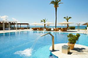 a swimming pool with a fountain in a resort at ROBINSON KYLLINI BEACH - All Inclusive in Kyllini