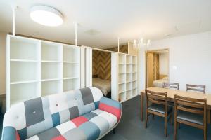 a room with a table and a couch and a bedroom at 優ハウス夢ハウス2階 in Furano