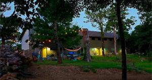 a house with a hammock in front of a yard at Bigfoot Hideout in Winslow
