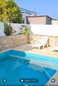 a villa with a swimming pool and a house at Casas da Praia in Foz do Arelho