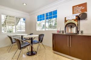 a coffee shop with two tables and a counter at Motel 6 Garden Grove in Anaheim