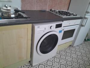 a washing machine in a kitchen next to a stove at Modern Seaside Stay at Bela Grove-Sleeps8 in Blackpool