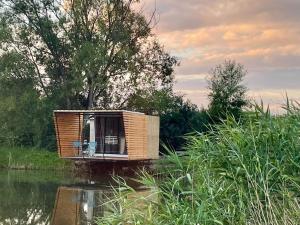 a small cabin in the middle of a river at Lake House in Vadu Crişului