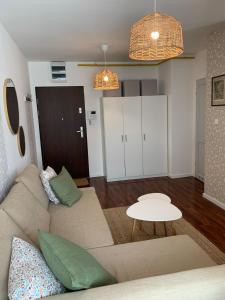 a living room with a couch and a table at Apartament Ogrodowa in Bielany Wrocławskie
