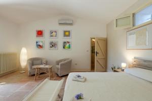 a bedroom with a bed and a table and chairs at Agriturismo Masseria Gianferrante in Ugento