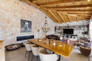 a dining room with a table and a brick wall at Villa Puccini with pool and sauna in Frata