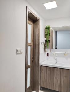 a bathroom with a sink and a mirror at Holiday Home at Forest City with TV Box & 3 Bedrooms 1 Bathroom 4-6pax 1618 in Gelang Patah