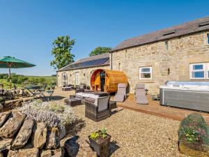 a stone house with a hot tub in a yard at 4 Bed in Birtley 92410 