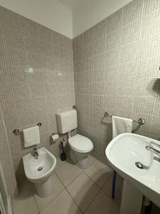 a bathroom with a toilet and a sink at Pollon Inn Sanremo in Sanremo