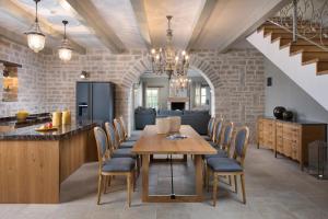 a kitchen and dining room with a table and chairs at Villa Elena with private pool and sport courts in Ladići