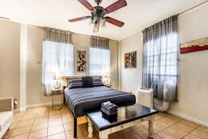 a bedroom with a bed and a ceiling fan at Casa Bonita Apartments in Long Beach