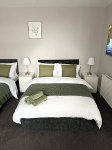a bedroom with a large bed and two lamps at The Mill House Sleep Inn in Hartlepool
