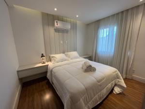 a bedroom with a large white bed and a window at Casa 05 Monte Boa Vista - Casa de Luxo na Serra com Sauna e 4 Suítes in Teresópolis +33 photos