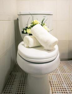 a white toilet in a bathroom with flowers on it at 젠하우스 수원화성 in Suwon +32 photos
