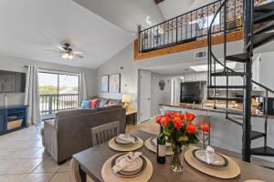 a living room and dining room with a couch and a table at Dog Friendly Pool Walk to Beach in Gulf Shores