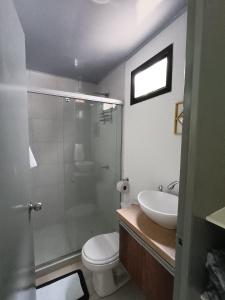 a bathroom with a shower and a toilet and a sink at Minca Seasons Birds in Minca