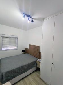 a bedroom with a bed and a ceiling fan at Ocean View JJ in Mongaguá +31 photos