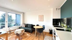 a kitchen and living room with a couch and a table at Loipenteufel - Zentral modern & am Lift mit Garage in Winterberg
