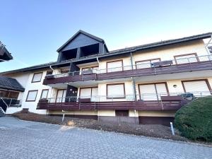 a building with balconies on the side of it at Loipenteufel - Zentral modern & am Lift mit Garage in Winterberg