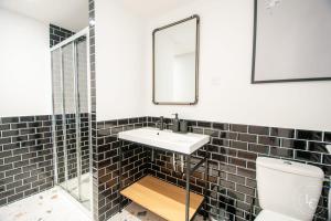 a bathroom with a sink and a toilet at Chambord Apartment Modern comfort near the Loire castles in Courbouzon