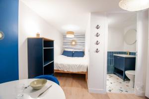 a small room with a bed and a bathroom at Le Cheverny Apartment Cozy stay near the Loire castles in Courbouzon +5 photos