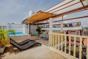 a balcony with a bench and a swimming pool at La Dominica Hotel Boutique in Cartagena de Indias