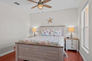 a bedroom with a bed and a ceiling fan at Waterfront View Oasis in Cape Coral +41 photos