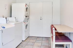 a white kitchen with a washer and dryer at Motel 6-Kelso, WA - Mt. St. Helens in Kelso