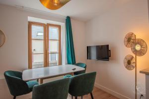 a room with a table and chairs and a window at Le Chenonceau Apartment Elegance and comfort in the Loire Valley in Courbouzon