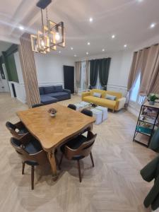 a living room with a table and a couch at Urban Nest in Beauvais