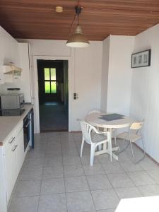 eine Küche mit einem Tisch, Stühlen und einem Tisch in der Unterkunft 3 Bedroom Cozy Apartment 30min zu Hamburg in Buchholz in der Nordheide