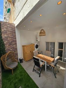 a patio with a table and chairs and a kitchen at Bear Homes - Olimpia Suite in Valencia +18 photos