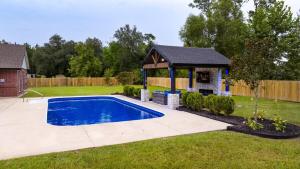 a swimming pool in a yard with a gazebo at The Gambler in Lake Charles
