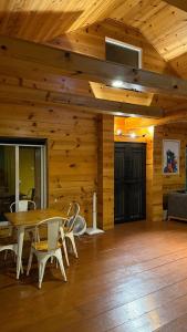 a room with a table and chairs and a ceiling at RBS Cottage in Murree
