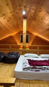 a room with a bed in a wooden cabin at RBS Cottage in Murree