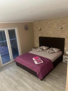 a bedroom with a bed with two towels on it at Studio Elena in Tivat