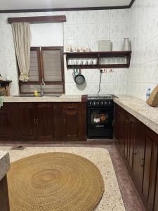 a kitchen with a stove and a counter top at Home sweet house in Zanzibar City