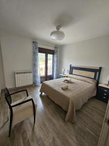 a bedroom with a large bed and a chair at El Cierzo de Sediles in Sediles